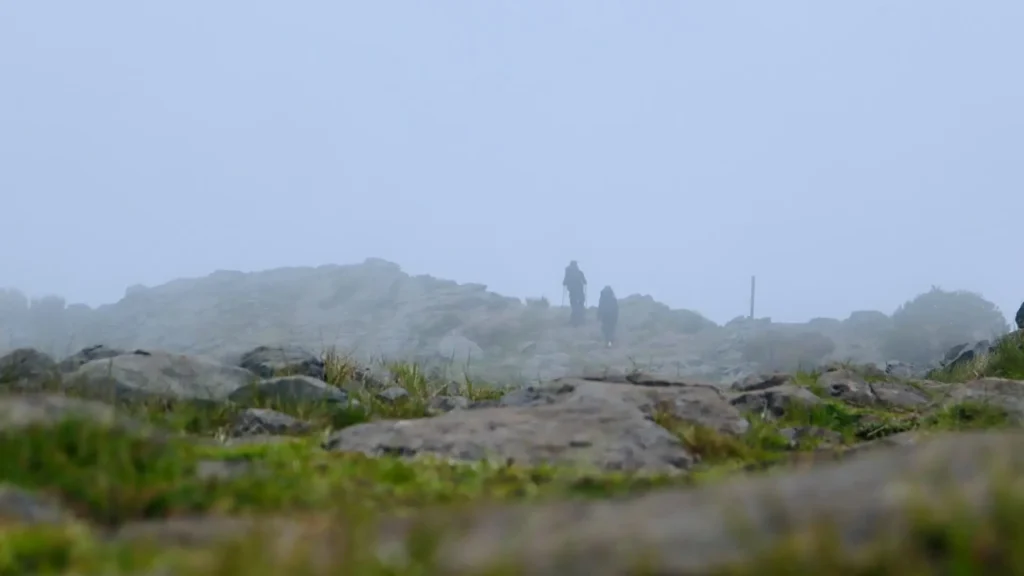 Minimalist backpacking hiker walking into fog