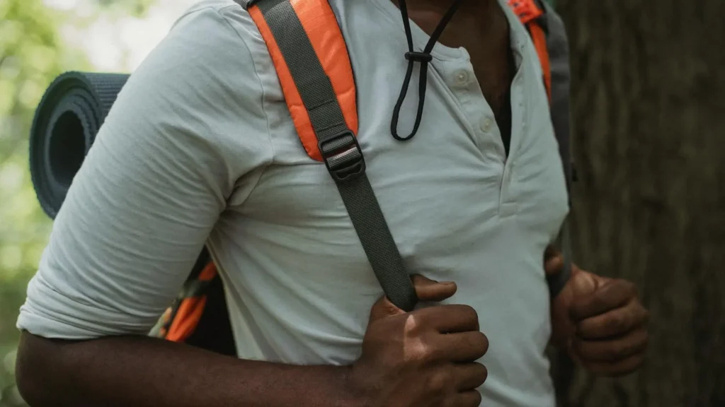 Minimalist macro shot of a hiker's shoulder on trail, breathable base layer achieving invisible thermoregulation for hiking